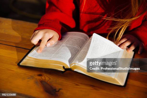 studying the words of the god - girl reading stock pictures, royalty-free photos & images