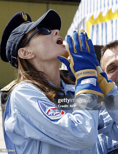 France's first lady Carla Bruni-Sarkozy patron of the French aerobatic squadron "Patrouille de France" reacts as she attends an exhibition in...