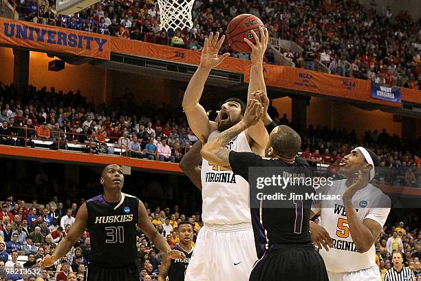 Deniz Kilicli of the West Virginia Mountaineers goes up for a shot attempt against the Washington Huskies during the east regional semifinal of the...