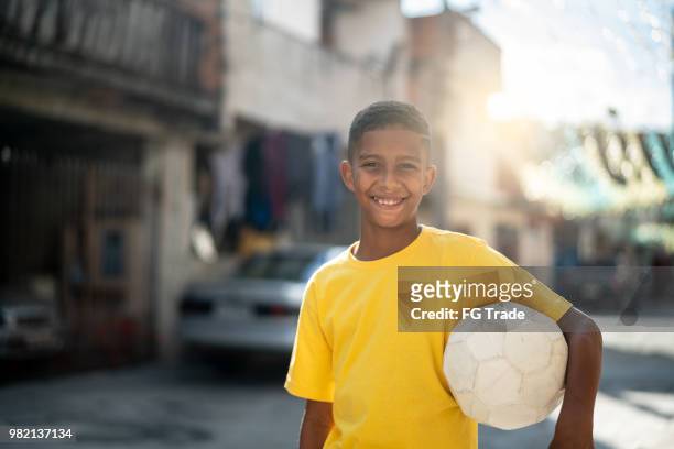 brazilian kid playing soccer portrait - poor kids playing soccer stock pictures, royalty-free photos & images