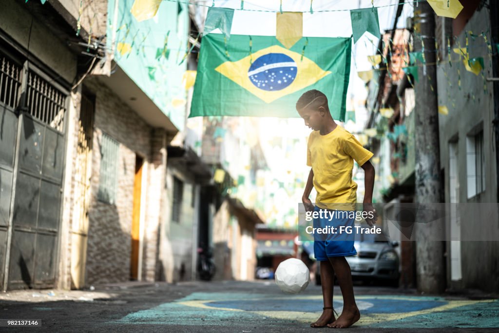 Brazilian Kid Playing Soccer in the Street