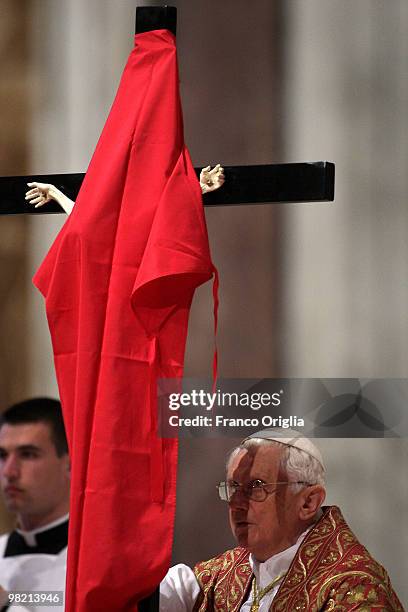 Pope Benedict XVI holds the cross as he conducts the Good Friday Passion of The Lord celebration at St. Peter's Basilica on April 2, 2010 in Vatican...