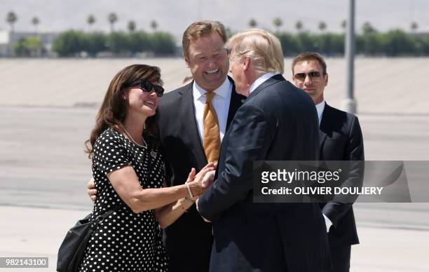 President Donald Trump is greeted by Republican Senator Dean Helle as he arrives aboard Air Force One at McCarran International airport in Las Vegas,...