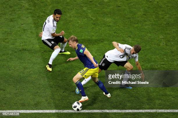 Emil Forsberg of Sweden is tackled by Ilkay Guendogan and Thomas Mueller of Germany during the 2018 FIFA World Cup Russia group F match between...