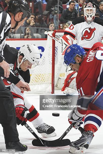 Patrik Elias of New Jersey Devils faces off with Scott Gomez of Montreal Canadiens during the NHL game on March 27, 2010 at the Bell Center in...