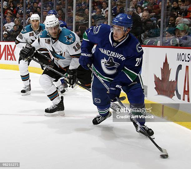 Patrick Marleau of the San Jose Sharks skates after Mason Raymond of the Vancouver Canucks as he skates up ice with the puck during the game at...