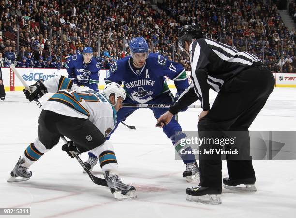 Scott Nichol of the San Jose Sharks and Ryan Kesler of the Vancouver Canucks square off for a face-off during the game at General Motors Place on...