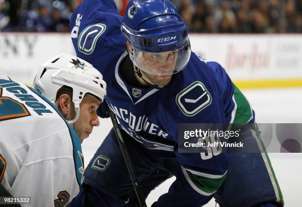 Scott Nichol of the San Jose Sharks and Pavol Demitra of the Vancouver Canucks square off for a face-off during the game at General Motors Place on...