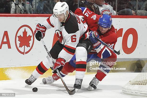 Andy Greene of New Jersey Devils battles for puck with Sergei Kostitsyn of Montreal Canadiens during the NHL game on March 27, 2010 at the Bell...