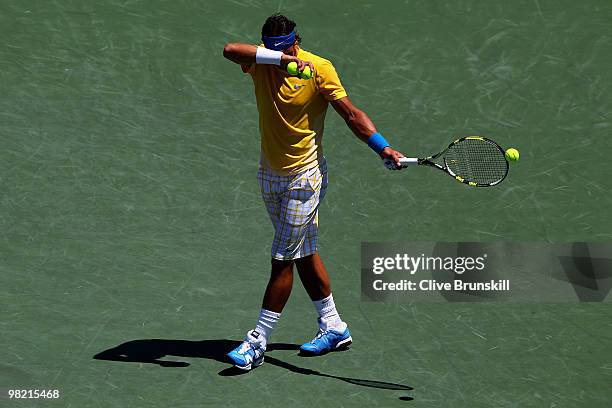 Rafael Nadal of Spain wipes his face while playing against Andy Roddick of the United States during day eleven of the 2010 Sony Ericsson Open at...