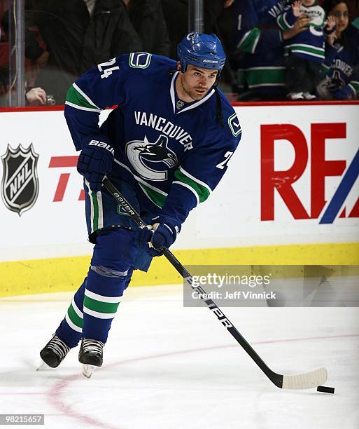 Darcy Hordichuk of the Vancouver Canucks skates up ice with the puck during the game against the San Jose Sharks at General Motors Place on March 18,...