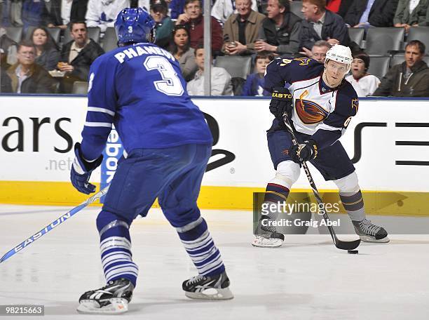 Dion Phaneuf of the Toronto Maple Leafs defends against Maxim Afinogenov of the Atlanta Thrashers during the game on March 30, 2010 at the Air Canada...