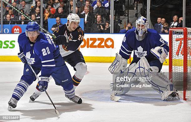 Francois Beauchemin of the Toronto Maple Leafs battles with Colby Armstrong of the Atlanta Thrashers in front of goalie Jonas Gustavsson during the...