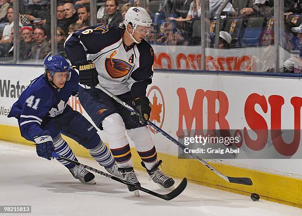 Nikolai Kulemin of the Toronto Maple Leafs battles for the puck with Ron Hainsey of the Atlanta Thrashers during the game on March 30, 2010 at the...