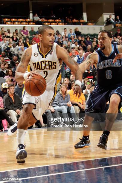 Earl Watson of the Indiana Pacers drives against Deron Williams of the Utah Jazz during the game on March 26, 2010 at Conseco Fieldhouse in...