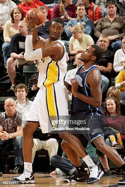 Roy Hibbert of the Indiana Pacers handles the ball against Paul Millsap of the Utah Jazz during the game on March 26, 2010 at Conseco Fieldhouse in...