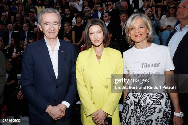 Model Bella Hadid standing between Owner of LVMH Luxury Group Bernard Arnault and his wife Helene Arnault attend the Dior Homme Menswear...