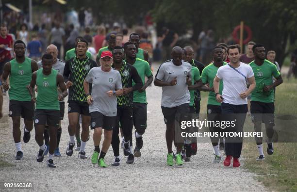 Nigerian players warm up at Essentuki Lake before heading to the arena to take part in a training session in Essentuki in southern Russia on June 23...