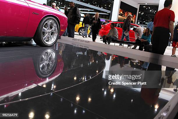 People look at car displays on the opening day of the New York International Auto Show on April 2, 2010 in New York City. The show, which opens to...