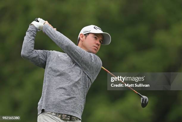 Brian Harman watches his tee shot on the fourth hole during the third round of the Travelers Championship at TPC River Highlands on June 23, 2018 in...