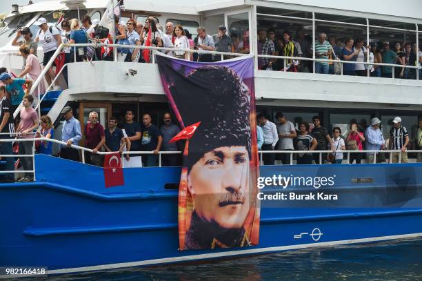 Supporters wave flags and cheer on ferries on their way to a rally for Muharrem Ince, presidential candidate of Turkey's main opposition Republican...