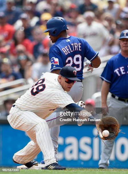 Adrian Beltre of the Texas Rangers reaches first base safely as Logan Morrison of the Minnesota Twins fields the ball during the second inning of the...