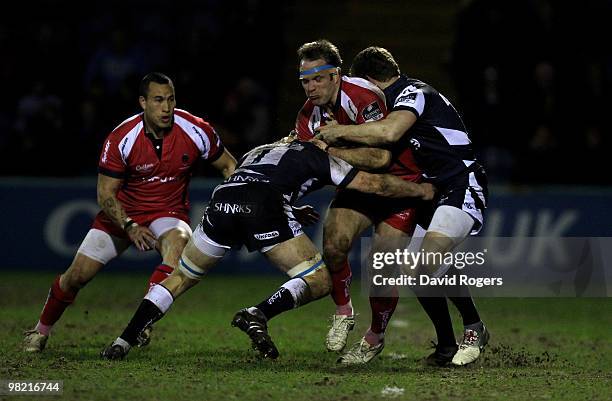 Kai Horstmann of Worcester is tackled by David Seymour and Richard Wigglesworth during the Guinness Premiership match between Sale Sharks and...