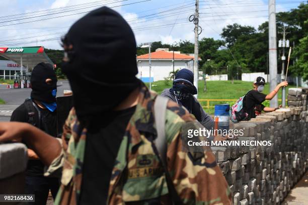 Students with homemade mortars remain at a barricade in the face of ongoing attacks from riot police and members of the Sandinista Youth, in the...