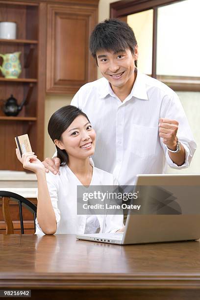 young couple shopping online - luxury home dining table people lifestyle photography people stock pictures, royalty-free photos & images