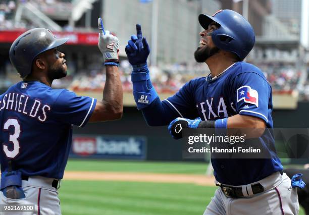 Delino DeShields of the Texas Rangers congratulates teammate Robinson Chirinos on a two-run home run against the Minnesota Twins during the third...