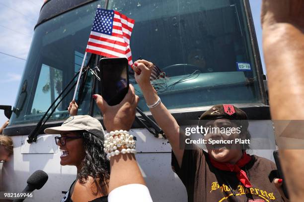 Protesters against the Trump administration's border policies try to block a bus carrying migrant children out of a U.S. Customs and Border...