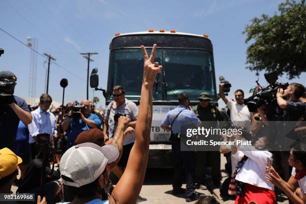 Protesters against the Trump administration's border policies try to block a bus carrying migrant children out of a U.S. Customs and Border...