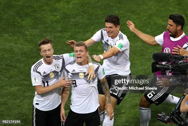 Toni Kroos of Germany celebrates with teammates Marco Reus and Mario Gomez after scoring his sides winning goal during the 2018 FIFA World Cup Russia...