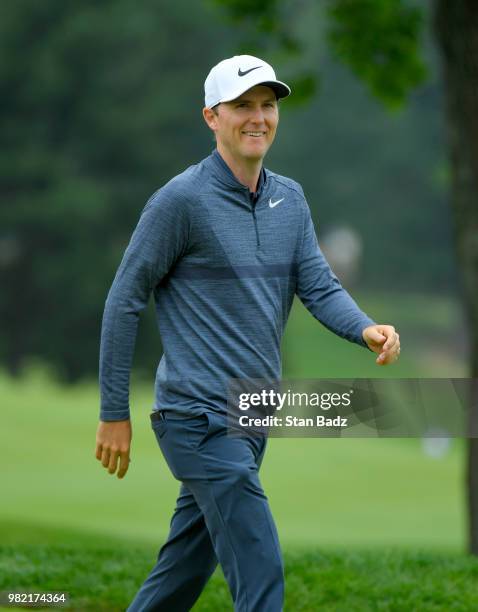 Russell Henley acknowledges the gallery on the second hole during the third round of the Travelers Championship at TPC River Highlands on June 23,...