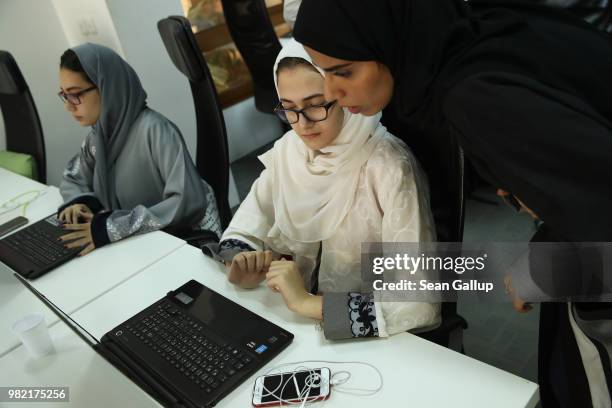 Raneem Younes an intern at Careem, a peer-to-peer ride sharing company similar to Uber, gets a little help from a supervisor at the Careem offices on...