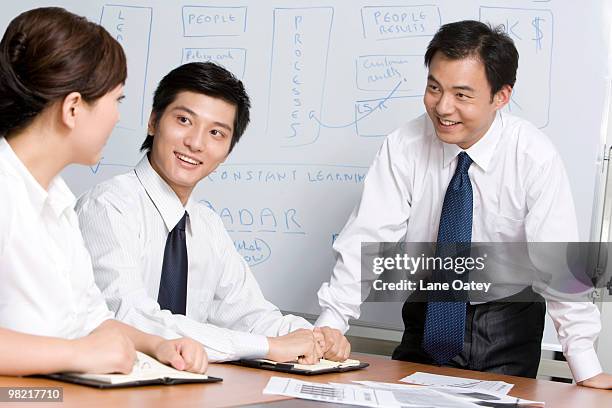 young businessmen have meeting in office - promotional event in beijing fotografías e imágenes de stock