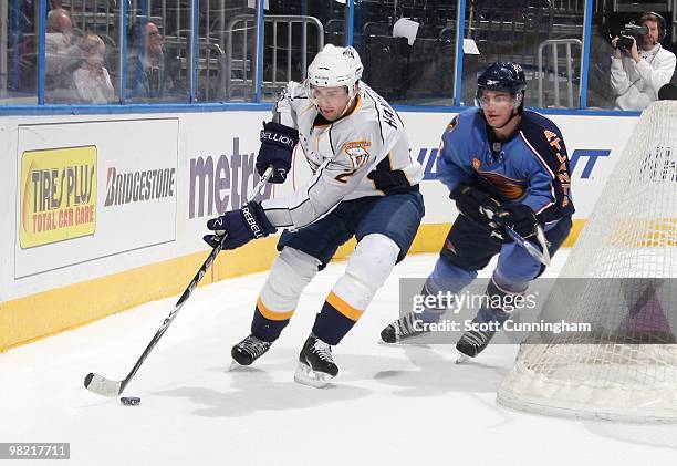 Dan Hamhuis the Nashville Predators carries the puck against Jim Slater of the Atlanta Thrashers at Philips Arena on March 9, 2010 in Atlanta,...