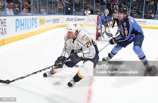 Steve Sullivan of the Nashville Predators carries the puck against Ron Hainsey of the Atlanta Thrashers at Philips Arena on March 9, 2010 in Atlanta,...