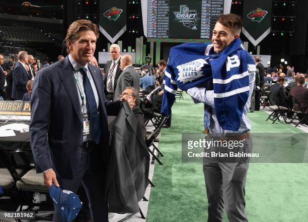 Head coach Mike Babcock helps Zachary Bouthillier after being selected 209th overall by the Toronto Maple Leafs during the 2018 NHL Draft at American...