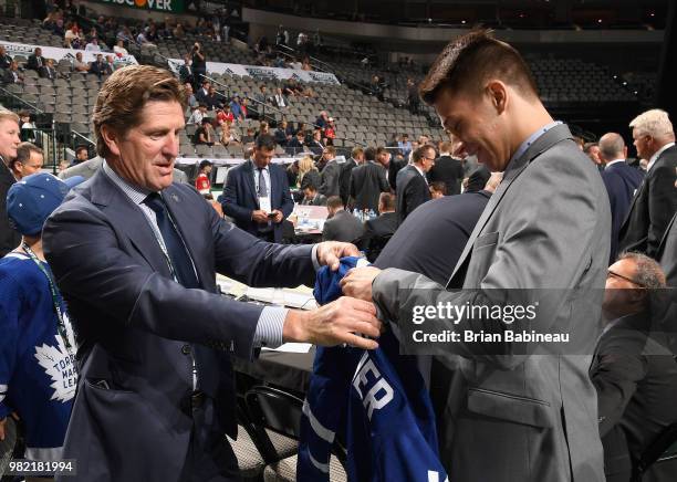 Head coach Mike Babcock helps Zachary Bouthillier after being selected 209th overall by the Toronto Maple Leafs during the 2018 NHL Draft at American...