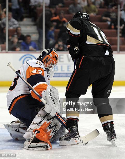 Martin Biron of the New York Islanders makes a save in front of Corey Perry of the Anaheim Ducks at the Honda Center on March 19, 2010 in Anaheim,...