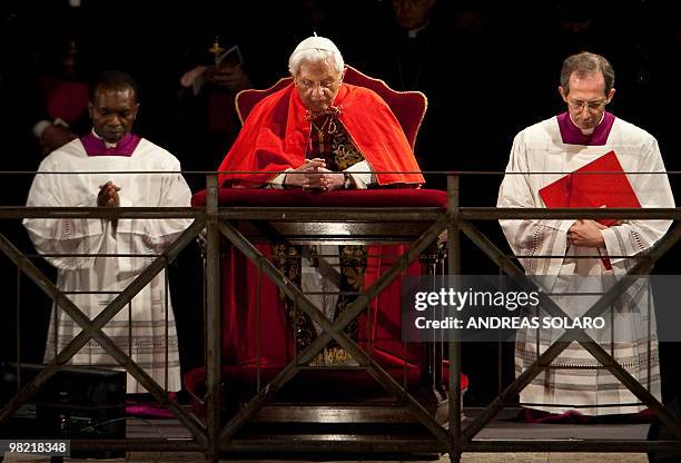 Pope Benedict XVI prays as he leads the Way of the Cross on Good Friday on April 2, 2010 at Rome's Colosseum. AFP PHOTO/ ANDREAS SOLARO