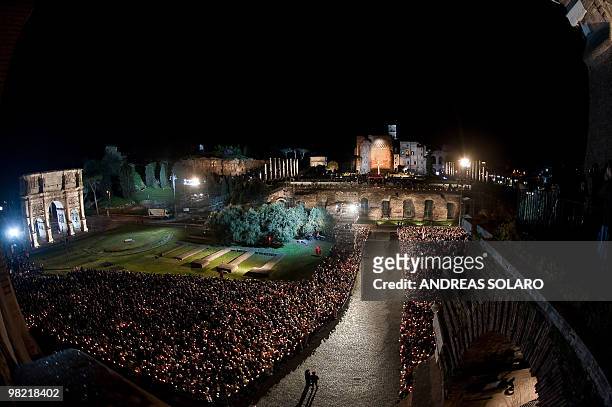 Faithful take place in front of Rome's Colosseum where Pope Benedict XVI will preside later in the evening the Way of the Cross on Good Friday on...
