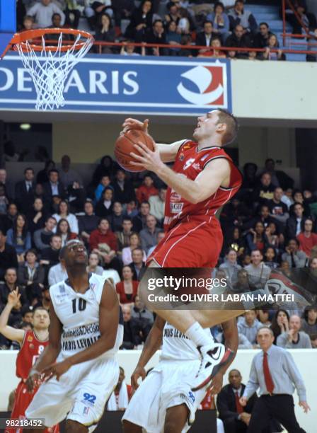 Cholet's Fabien Causeur scores in front of Paris Levallois' French winger Wilfrid Aka during their French ProA basketball match in Paris on April 2,...