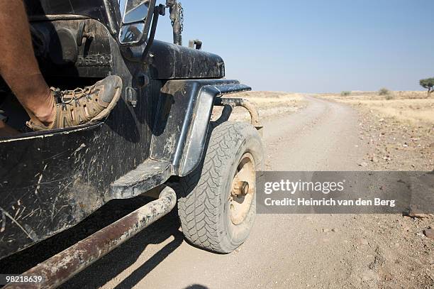 low angle view of side of motor vehicle with drivers foot resting on the frame work, marienflusstal  - freek van den bergh stock pictures, royalty-free photos & images