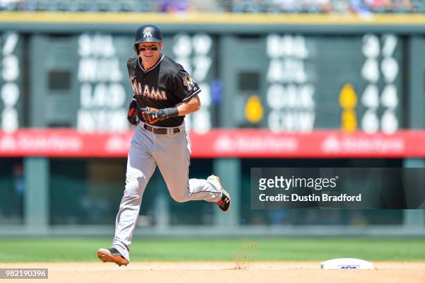 Derek Dietrich of the Miami Marlins rounds the bases after hitting a fourth inning solo homerun against the Colorado Rockies at Coors Field on June...