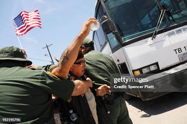 Protester against the Trump administration's border policies tries to block a bus carrying migrant children out of a U.S. Customs and Border...