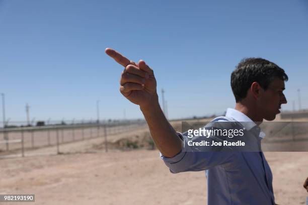 Rep. Beto O'Rourke points toward the tent encampment he toured near the Tornillo-Guadalupe Port of Entry on June 23, 2018 in Tornillo, Texas. A tent...