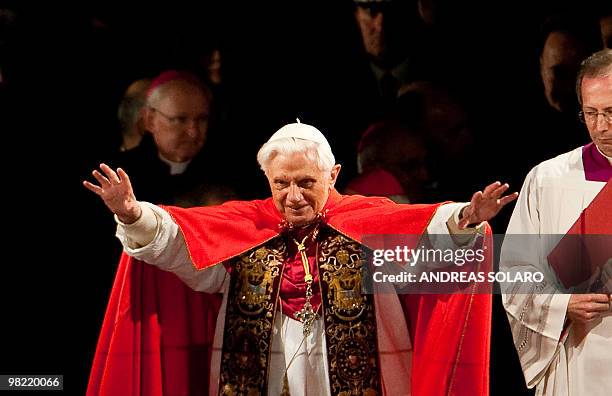 Pope Benedict XVI blesses faithful as he leads the Way of the Cross on Good Friday on April 2, 2010 at Rome's Colosseum. AFP PHOTO/ ANDREAS SOLARO