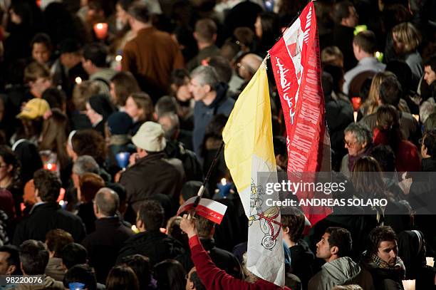 Faithful hold candles and flags during the Way of the Cross on Good Friday on April 2, 2010 at Rome's Colosseum. AFP PHOTO/ ANDREAS SOLARO